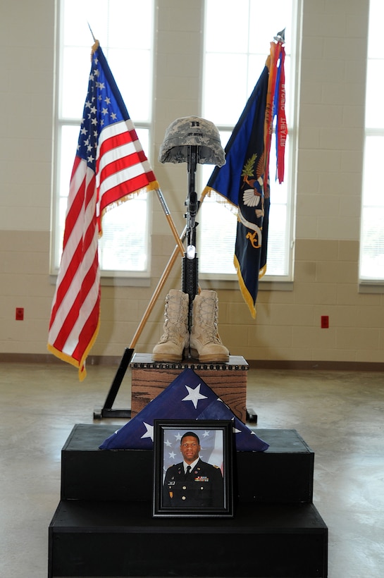 A picture of Army Reserve Capt. Antonio D. Brown and the Fallen Soldier battle cross stand in the drill hall of the U.S. Army Reserve’s 3rd Battalion, 383rd Regiment, in St. Louis June 25, 2016, during a Fallen Soldier memorial. Brown was one of the 49 victims killed in the shooting at an Orlando, Florida nightclub June 12, 2016. (U.S. Army photo by Sgt. Aaron Berogan/Released)