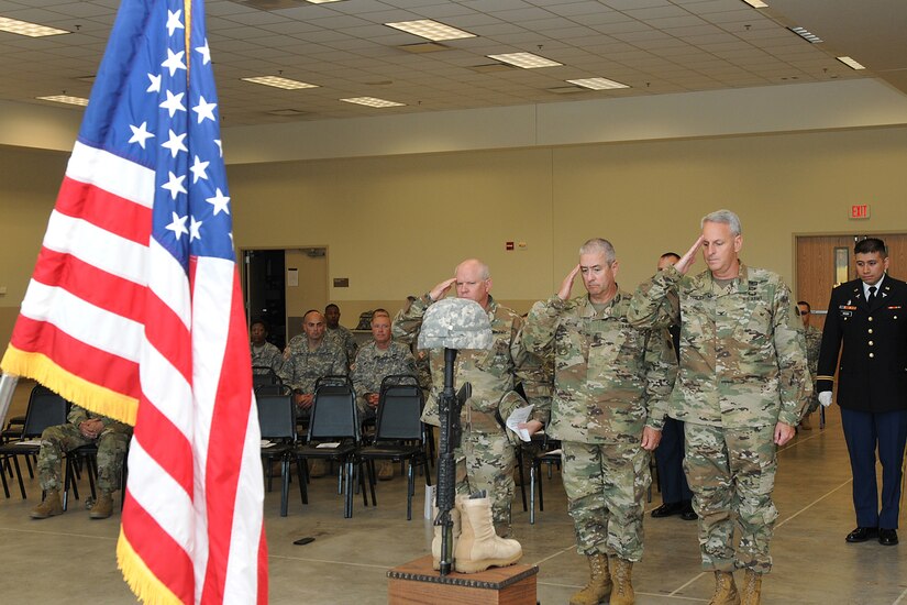 From left to right: Army Reserve Col. Joel Severson, Command Sgt. Maj. Kevin Greene, and Col. Robert Cooley, all assigned to 85th Support Command, salute the Fallen Soldier battle cross display during a Fallen Soldier memorial held June 25, 2016 at the 3rd battalion, 383rd Regiment in St. Louis. Capt. Antonio D. Brown, a 3-383rd member, was one of the 49 victims killed in the Orlando nightclub shooting June 12, 2016.
(U.S. Army photo by Sgt. Aaron Berogan/Released)