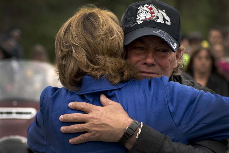 Fred Becker V hugs Alaska Senator Lisa Murkowski at the funeral for his father, Fred "Bulldog" Becker IV, June 24. Bulldog was heavily involved in the Anchorage community, and more than 1,000 Airmen and Soldiers lined the streets for his processional, consisting of hundreds of motorcyclists from around the community. (U.S. Air Force photo by Senior Airman Kyle Johnson)