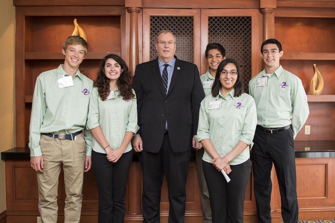 Deputy Defense Secretary Bob Work pauses for a photo with military children while participating in the Military Child Education Coalition's 2016 National Training Seminar in Washington, D.C., June 28, 2016. DoD photo by Air Force Staff Sgt. Brigitte N. Brantley