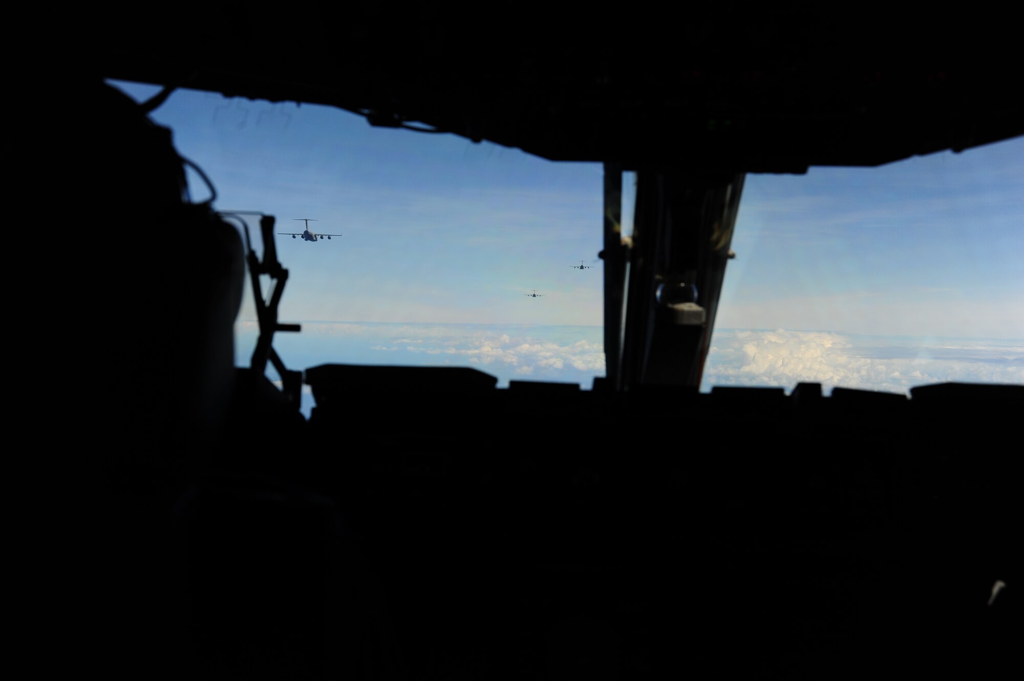 C-17 Globemaster pilot Capt. Josh Dove joins the formation during Warrior Day over Oahu, Hawaii, June 23, 2016. Warrior Day, which is a local exercise designed to demonstrate the ability to generate a large package of aircraft for forcible entry operations in the Pacific, involved seven C-17s, four F-22s, Air Force and Navy radar controllers, operators from the Special Operations Command, Pacific, and Army personnel from the Pohakuloa Training Area on the Big Island of Hawai’i.  (U.S. Air Force photo by 2nd Lt. Kaitlin Daddona/Released)