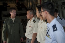 U.S. Air Force Capt. Joshua Radford, 17th Special Operations Squadron pilot, briefs a group of Japan Air Self-Defense Force and Japan Ground Self-Defense Force members attending the 52nd Joint Tactical Operations Course about the mission and capabilities of the MC-130J Commando II during a tour June 21, 2016, at Kadena Air Base, Japan. Most of the JASDF and JGSDF members on tour are pilots, so interacting with U.S. Air Force pilots creates stronger bilateral ties with between the militaries of Japan the U.S. (U.S. Air Force photo by Airman 1st Class Corey M. Pettis)