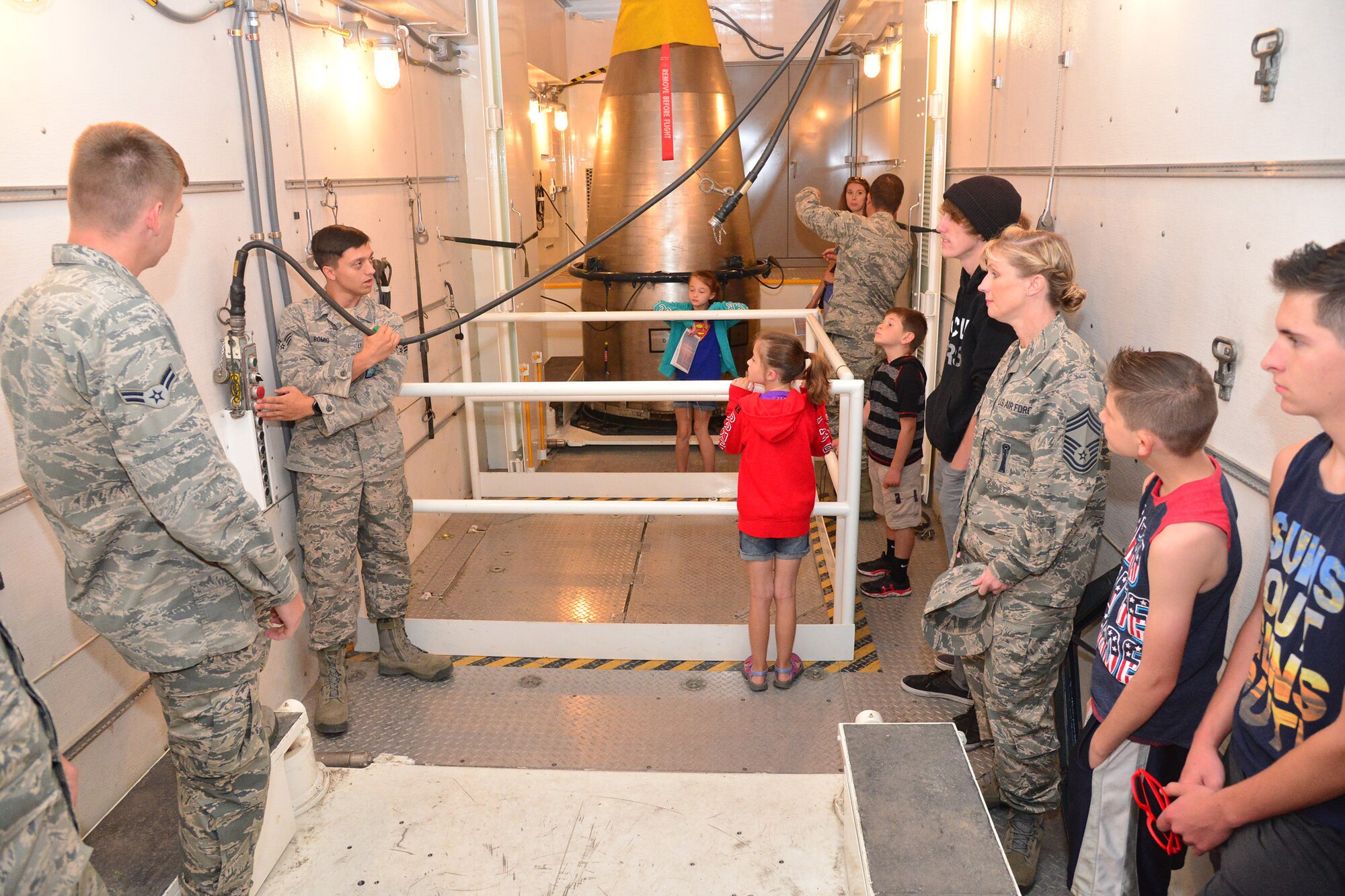 Family members of Airmen from the 341st Maintenance Group tour a maintenance vehicle during an open house at the 3-Bay Hangar June 27, 2016, at Malmstrom Air Force Base, Mont. The goal of the open house was to educate spouses and families to help them better understand the role of their Airmen in executing the nuclear deterrence mission. (U.S. Air Force photo/ Airman 1st Class Daniel Brosam)