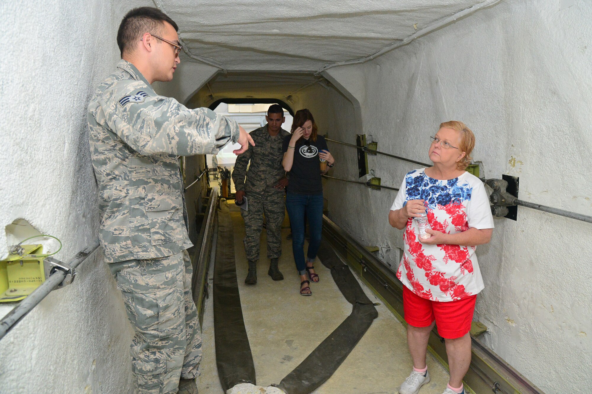 Senior Airman Christopher Blessing, 341st Missile Maintenance Squadron member, briefs a guest during an open house at the 3-Bay Hangar June 27, 2016, at Malmstrom Air Force Base, Mont. The 341st Maintenance Group supplied vehicles for families to enter and inspect to get a better understanding of maintenance’s mission. (U.S. Air Force photo/ Airman 1st Class Daniel Brosam)