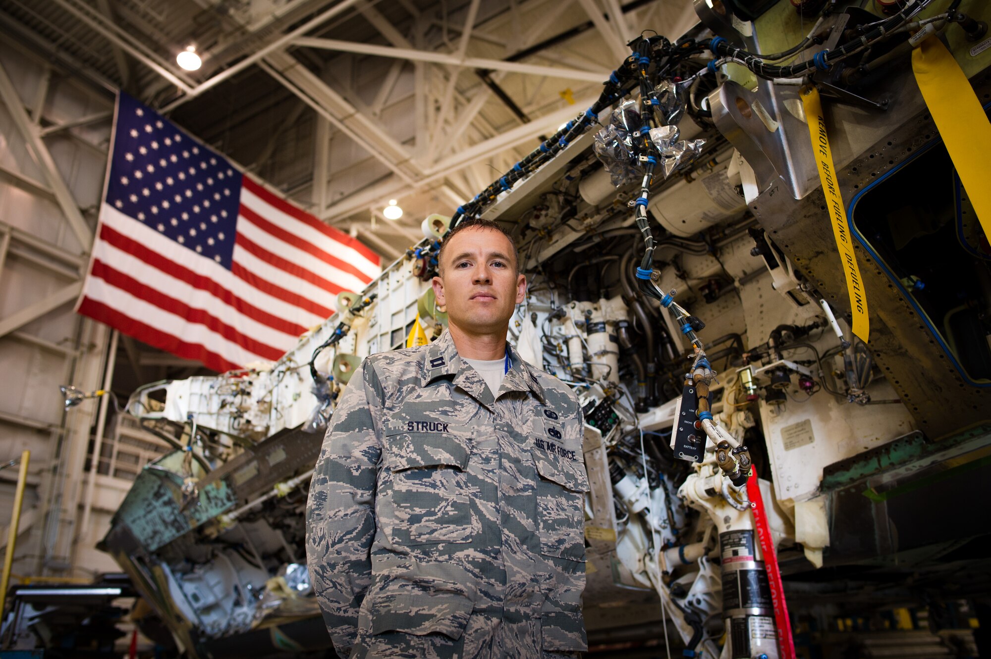 Capt. Jared Struck, an aircraft maintenance officer assigned to the Ogden Air Logistics Complex, poses beside an F-22 Raptor aircraft undergoing modifications at Hill Air Force Base, June 27. Struck is training to run the Badwater ultramarathon in July. Badwater is a 135-mile endurance race which begins in Death Valley and ends on Mount Whitney, both locations in California. (U.S. Air Force photo by R. Nial Bradshaw)