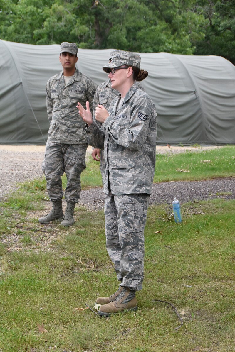 VOLK FIELD, WI- Staff Sgt. Dena Leonard, 114th Services Flight shelter platform expert, briefs Airmen prior to assembling the small shelter system during home station training June 20-26.  (U.S. Air National Guard photo by Tech. Sgt. Abbey Rotter/Released)