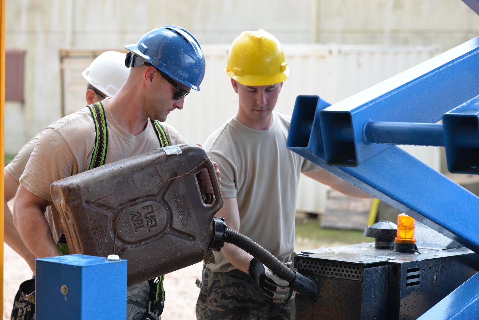 From the left, New Hampshire Air National Guardsmen Tech. Sgt. Ben Kipp and Senior Airman Benjamin Keeler fill up a scissor lift vehicle, Andersen Air Force Base, June 21, 2016. The 157 CES Airmen are deployed to Guam for annual training where they are working on the Commando Warrior Field Training facility, part of an ongoing construction project at the Pacific Command Regional Training Center. (Air National Guard photo by Tech. Sgt. Aaron Vezeau)