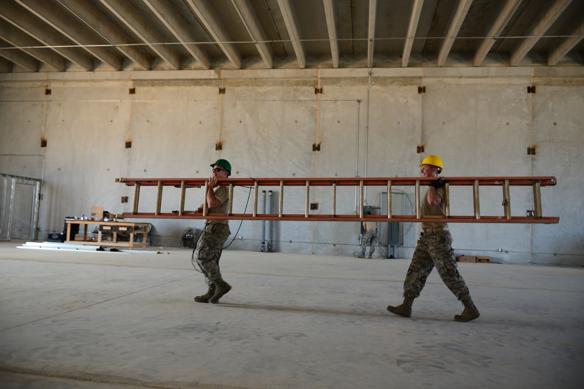From the left, U.S. Air Force Tech. Sgt. Donald Linscott and Staff Sgt. Ben Keeler, both assigned to the 157th Civil Engineering Squadron, New Hampshire Air National Guard, carry a ladder during construction on the Commando Warrior Training Facility, Andersen Air Force Base, Guam, June 20, 2016. 157 CES Airmen are deployed to Guam for annual training where they are working on a construction project for the Pacific Command Regional Training Center. (Air National Guard photo by Airman 1st Class Ashlyn J. Correia)
