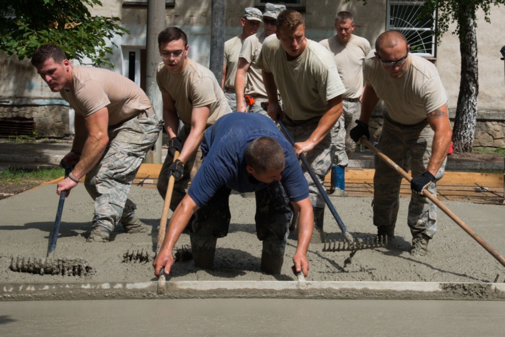 U.S. Airmen, assigned to the 185th Civil Engineering Squadron, Iowa Air National Guard, participate in the construction of a basketball court as part of a Humanitarian Civil Assistance (HCA) project in Chisinau, Moldova, June 22, 2016. As part of the European Command’s (EUCOM) Humanitarian and Civic Assistance Program, the 123rd Civil Engineering Squadron from the Kentucky Air National Guard, 185th Engineering Squadron from the Iowa Air National Guard, 457th Civil Affairs Battalion and Moldovan Land Forces collaborate to renovate to the kitchen at Special School Number 12 for Hearing Impaired Children, in Chisinau, Moldova, June 3-25, 2016. (U.S. Army Photo by Pfc. Emily Houdershieldt/released) 