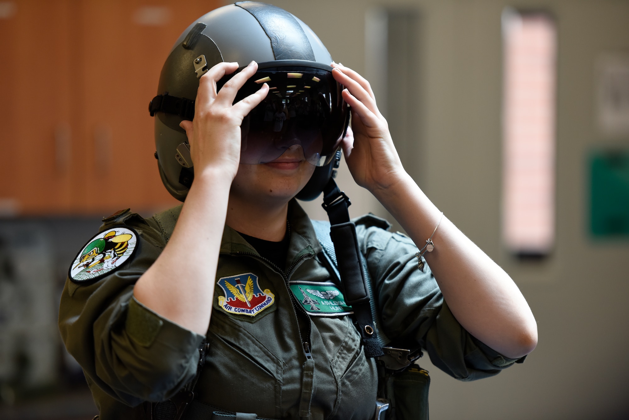 Honorary 2nd Lt. Ashleigh Hunt tries on a pilot’s helmet May 26, 2016 during Pilot for a Day at the 180th Fighter Wing in Swanton, Ohio. Pilot for a Day, a program supporting children and young adults who live with chronic or life-threatening illnesses, allows the 180FW to give back to the local community, whose enduring support for the Airmen makes the 180FW mission possible. (U.S. Air National Guard photo by Staff Sgt. Shane Hughes)