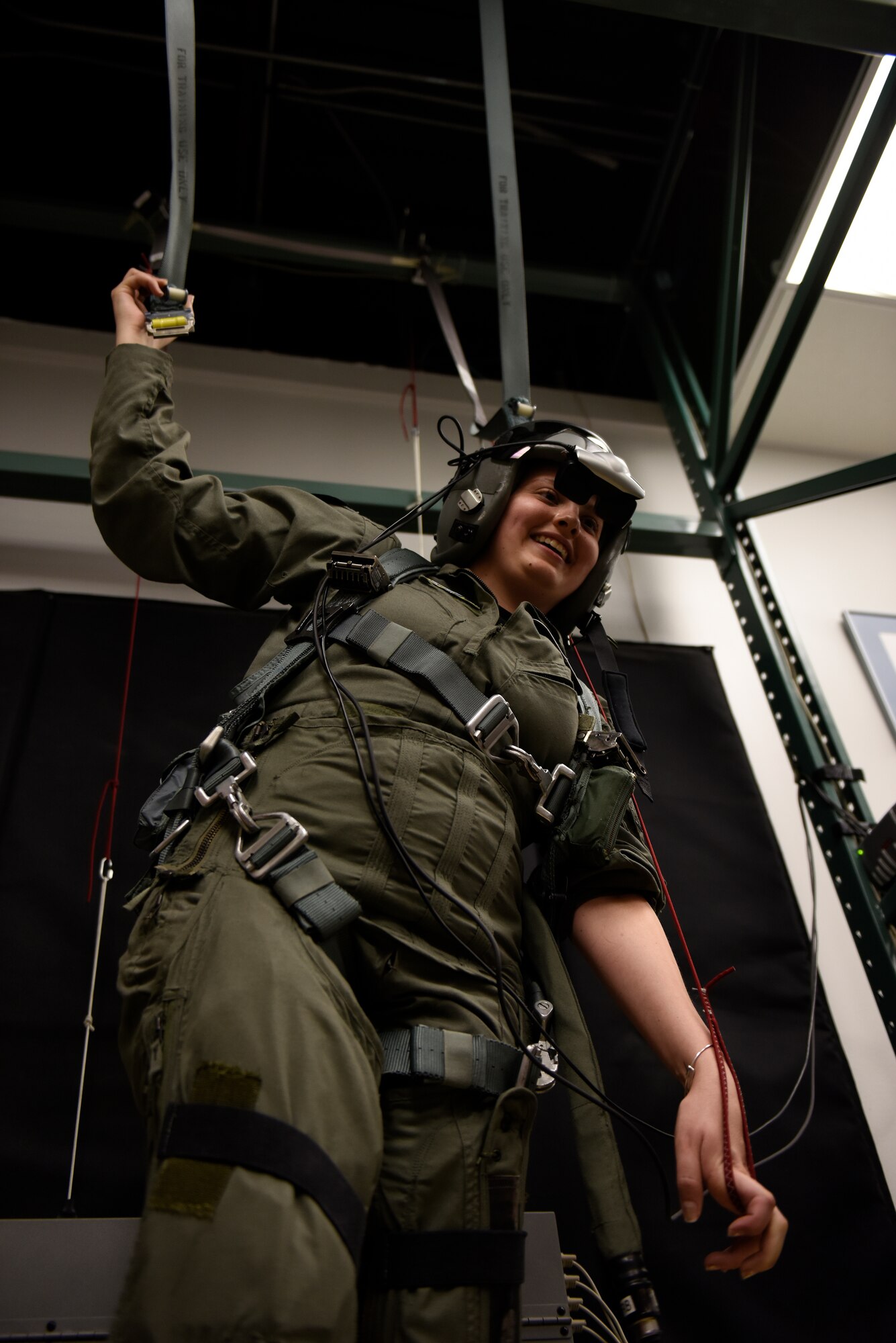 Honorary 2nd Lt. Ashleigh Hunt trains in a parachute simulator May 26, 2016 during Pilot for a Day, a program supporting children and young adults who live with chronic or life-threatening illnesses. Hunt, who was diagnosed with osteosarcoma at 19, was honored during the first-ever Pilot for a Day event at the 180th Fighter Wing where she launched an F-16 Fighting Falcon, received a tour of the base facilities, and experienced basic pilot survival training. (U.S. Air National Guard photo by Staff Sgt. Shane Hughes)