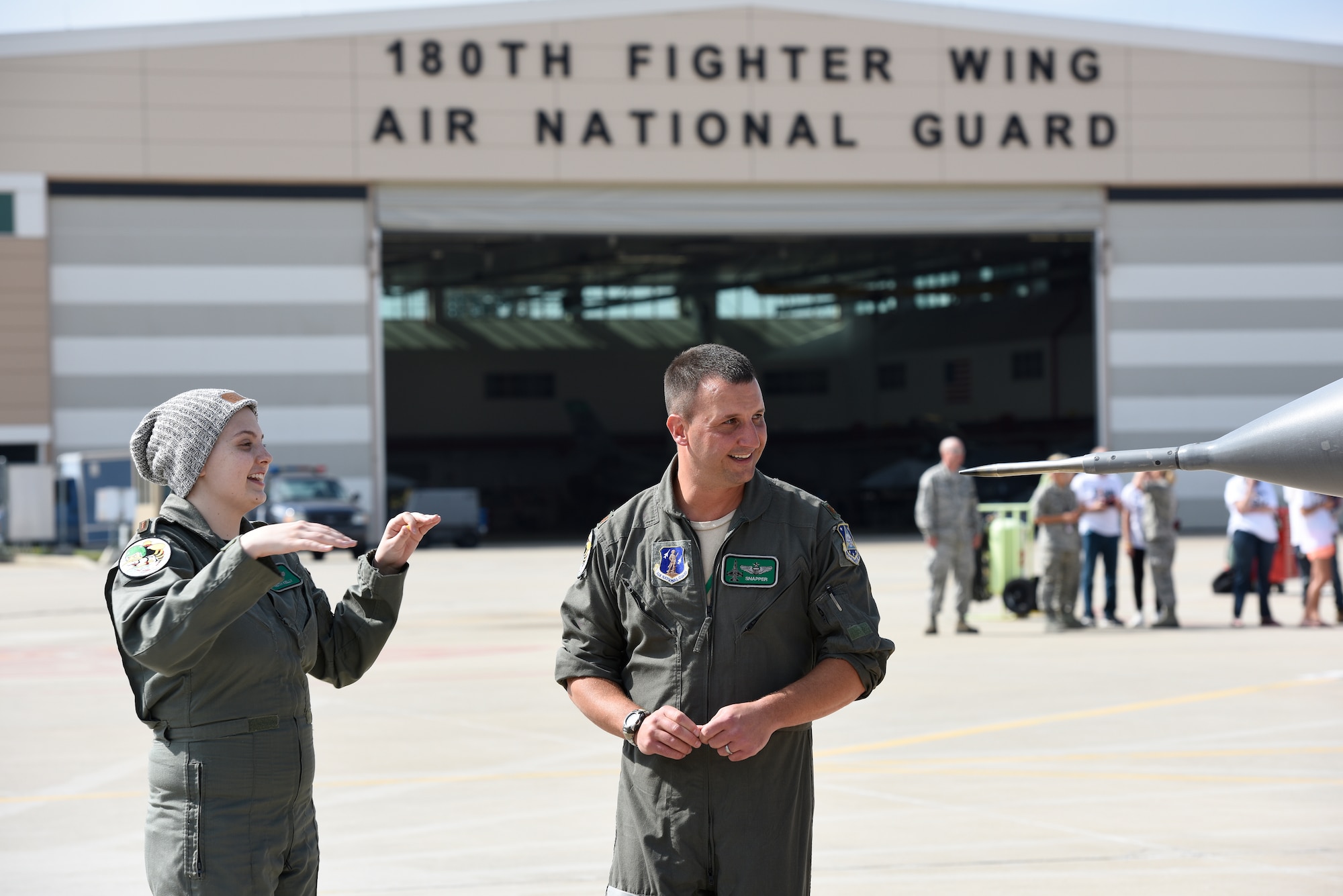 Honorary 2nd Lt. Ashleigh Hunt and U.S. Air Force Maj. Brian Cherolis, an F-16 Fighting Falcon pilot assigned to the 180th Fighter Wing, talk on the flight line prior to take-off May 26, 2016 during Pilot for a Day, a program supporting children and young adults who live with chronic or life-threatening illnesses. The Pilot for a Day program allows the 180FW to give back to the local community, whose enduring support for the Airmen makes the 180FW mission possible. (U.S. Air National Guard photo by Staff Sgt. Shane Hughes)