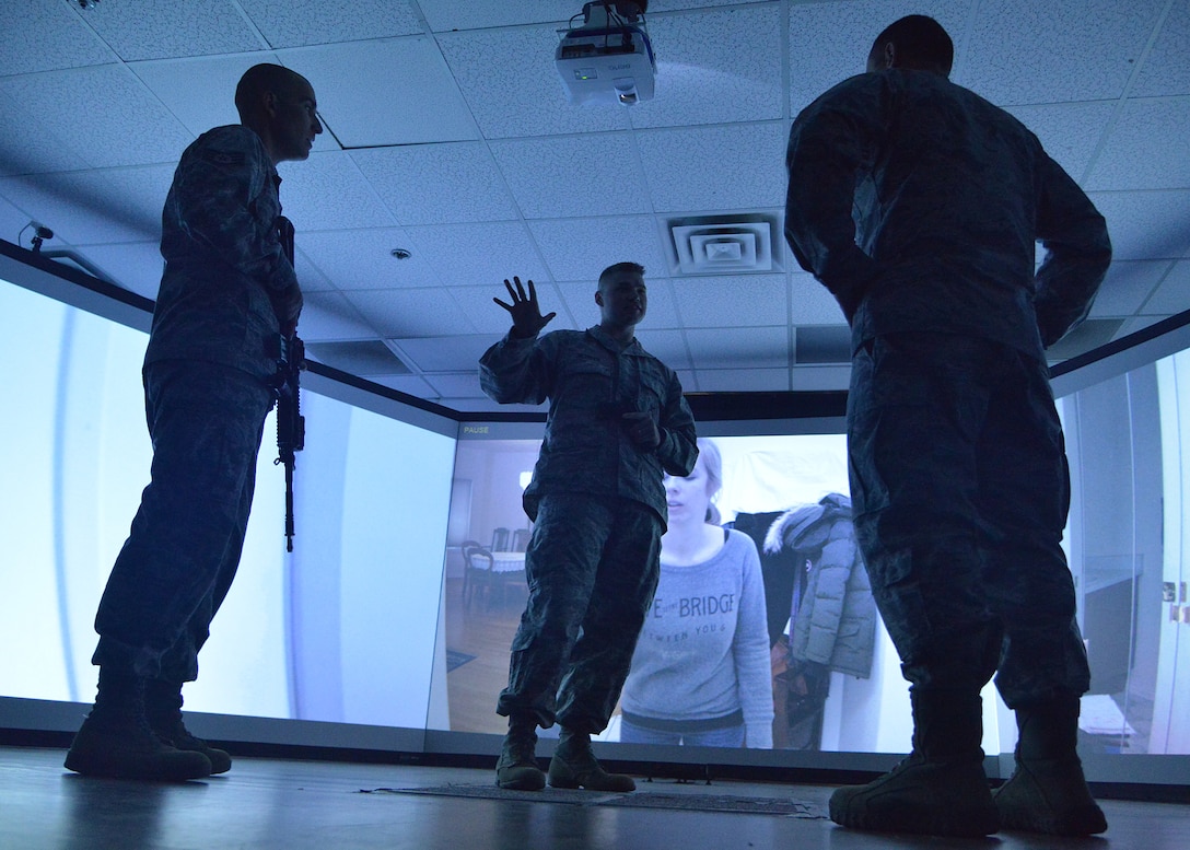 From left, Staff Sgt. Brandon Gomez listens as Tech. Sgt. Justin Jacobsen briefs Col. Eric Froehlich on the domestic disturbance simulation he was about to go through June 14, when the 377th Security Forces Squadron unveiled the MILO Range training simulator. (Photo by Todd Berenger)