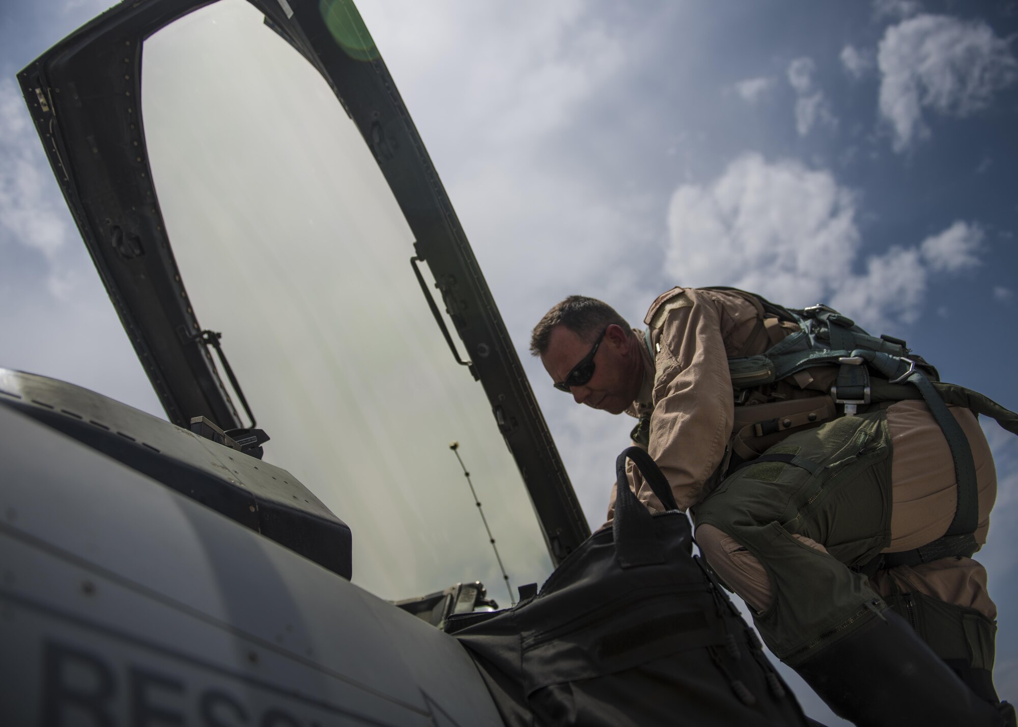 Lt. Col. David Efferson, 457th Expeditionary Fighter Squadron commander, climbs in the cockpit of an F-16C Fighting Falcon, June 28, 2016, Bagram Airfield, Afghanistan. The mission of the F-16C is to provide close air support for Operation Freedom’s Sentinel. (U.S. Air Force photo by Senior Airman Justyn M. Freeman)