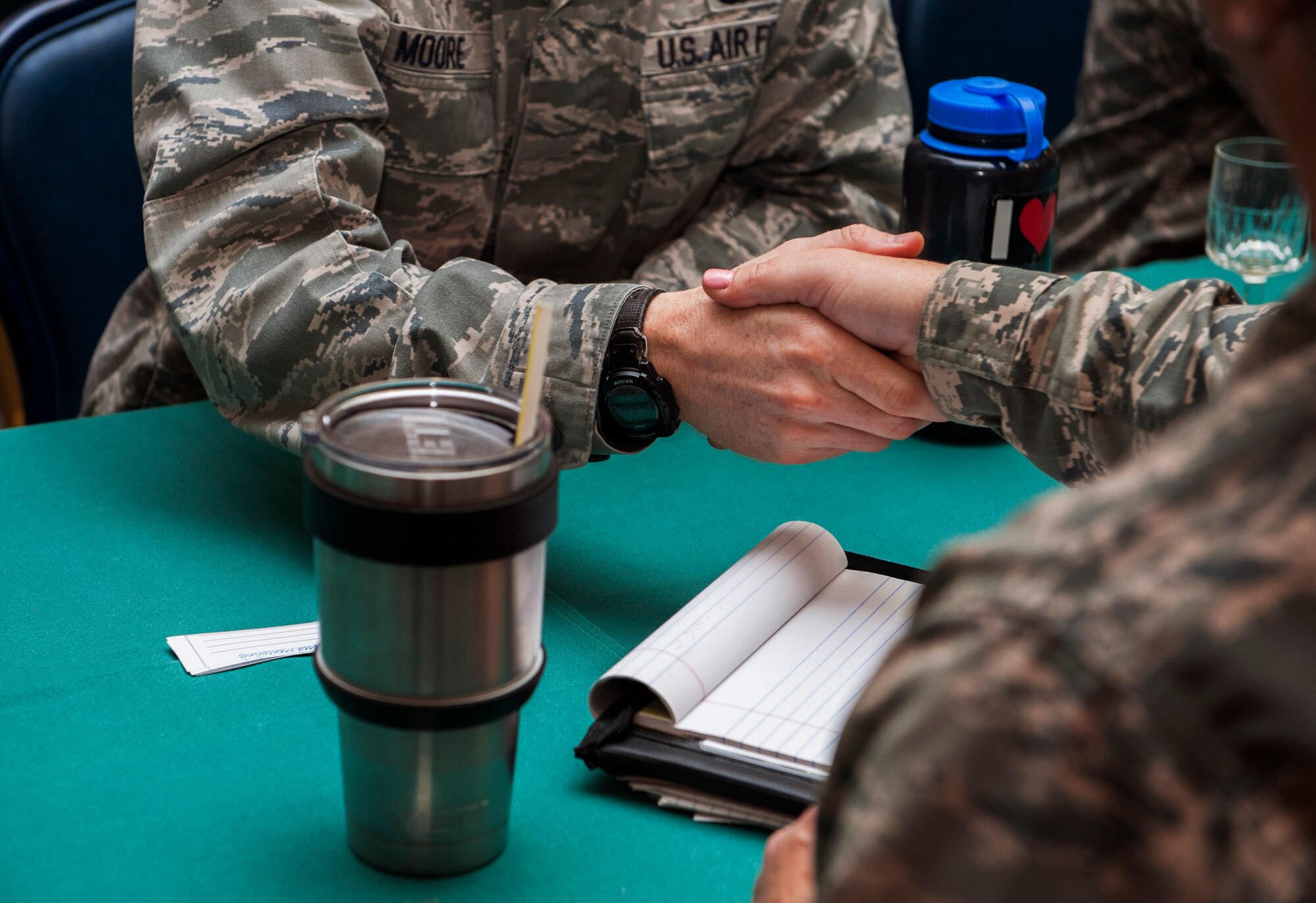 Participants of the speed mentoring session shake hands during the event at Club Eifel on Spangdahlem Air Base, Germany, June 28, 2016. The mentoring allowed the participants to exchange advice and contact information. (U.S. Air Force photo by Airman 1st Class Timothy Kim/Released)