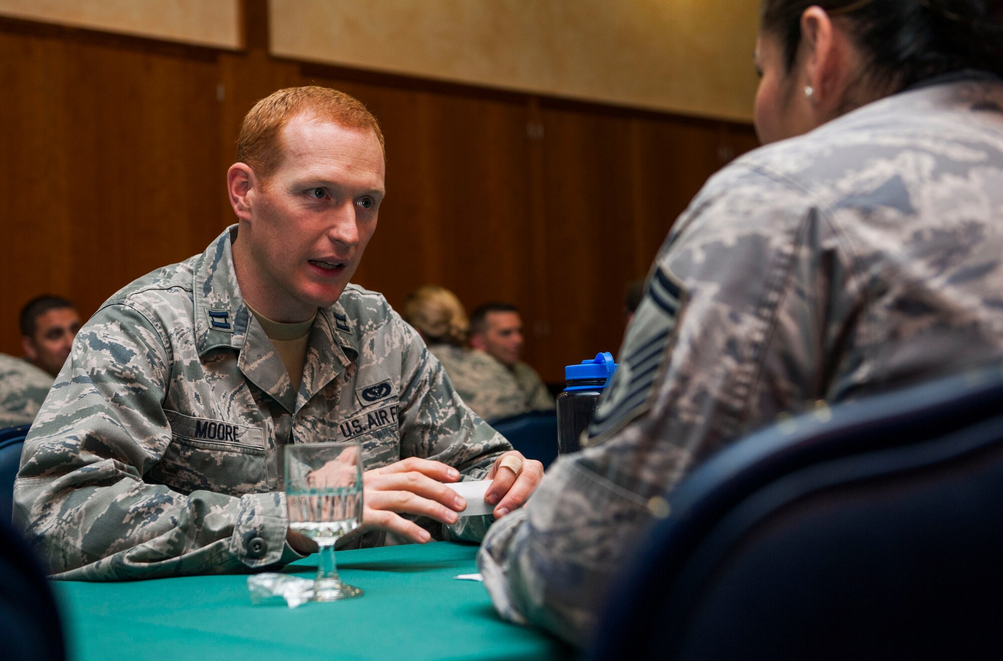 U.S. Air Force Capt. Brigham Moore, 52nd Civil Engineer Squadron operations engineering chief, speaks with a senior NCO mentor during a speed mentoring session at Club Eifel on Spangdahlem Air Base, Germany, June 28, 2016. All 13 company grade officers had the opportunity to meet and receive advice on leadership from all 19 senior NCOs. (U.S. Air Force photo by Airman 1st Class Timothy Kim/Released)