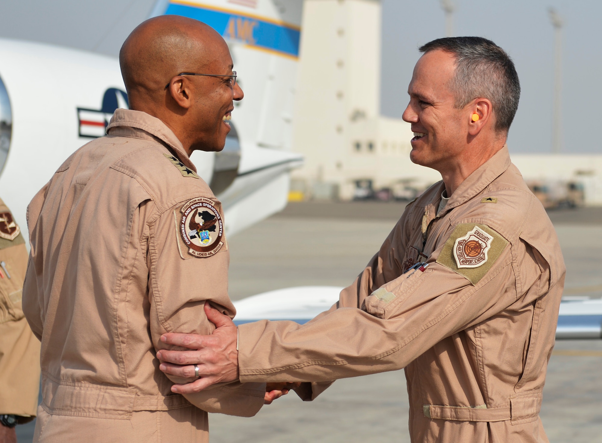 Brig. Gen. Charles Corcoran, 380th Air Expeditionary Wing commander, right, greets Lt. Gen. Charles Q. Brown, Jr., U.S. Air Forces Central Command commander, upon his arrival at an undisclosed location in Southwest Asia June 28, 2016. Brown visited the location to interact with members of the wing and to officiate over the 380th AEW change of command ceremony. (U.S. Air Force photo by Tech. Sgt. Chad Warren)
