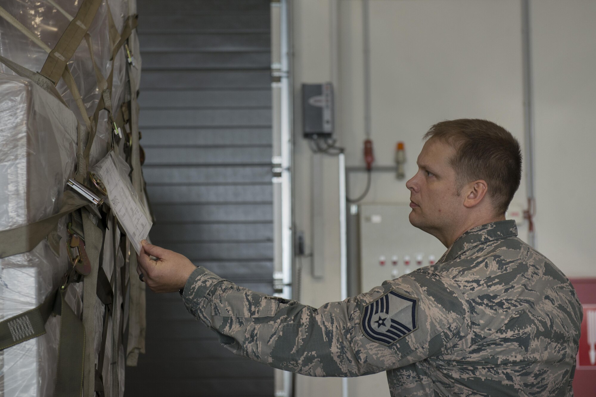 Master Sgt. Ryan Armour, 721st Aerial Port Squadron safety superintendent, checks the safety information on a pallet June 28, 2016, at Ramstein Air Base, Germany. Airmen from the 721st APS often use forklifts and load heavy cargo into large aircrafts, and the safety office helps to prevent injuries or damage to equipment. (U.S. Air Force photo/Airman 1st Class Tryphena Mayhugh)