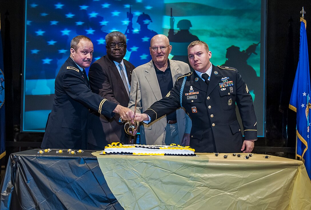 The ceremonial cutting of the cake is an annual Army birthday tradition. Pictured (l-r) are Chief Warrant Officer 3 Paul Pitzer, the oldest soldier at the event; Milton Lewis, Land and Maritime acquisitions executive; Army Maj. Gen. (ret.) Dennis Laich; and Sgt. Nicholas Noren, the youngest soldier in attendance.
