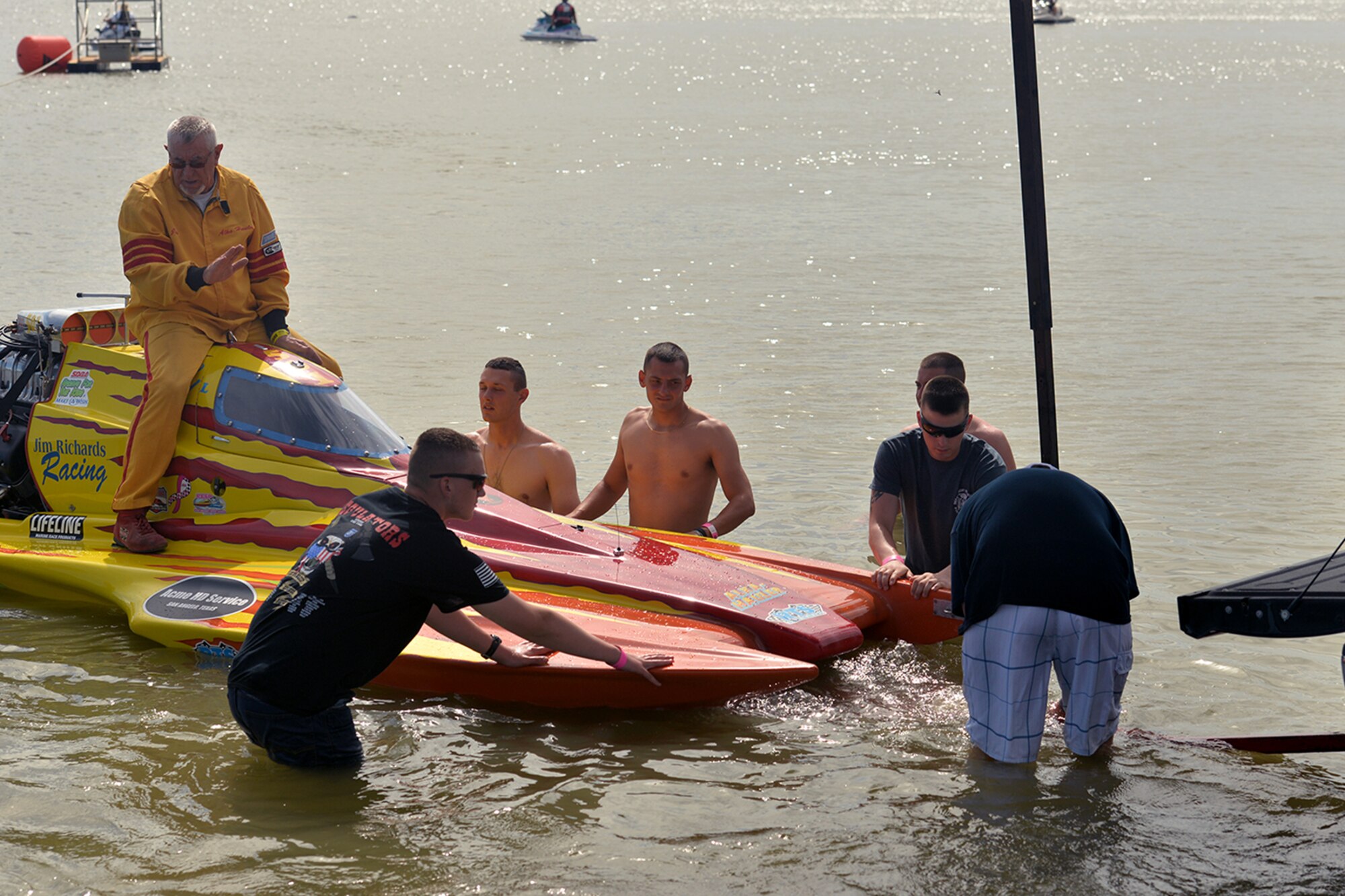 Goodfellow volunteers help Jim Richards, driver of “Alka-Hauler,” onto a trailer during the Showdown in San Angelo Super National drag boat race at Lake Nasworthy, San Angelo, Texas, June 25, 2016. Over 50 Goodfellow volunteers assisted with the boat race, continuing the partnership between the base and the San Angelo community. (U.S. Air Force photo by Airman 1st Class Randall Moose/Released)