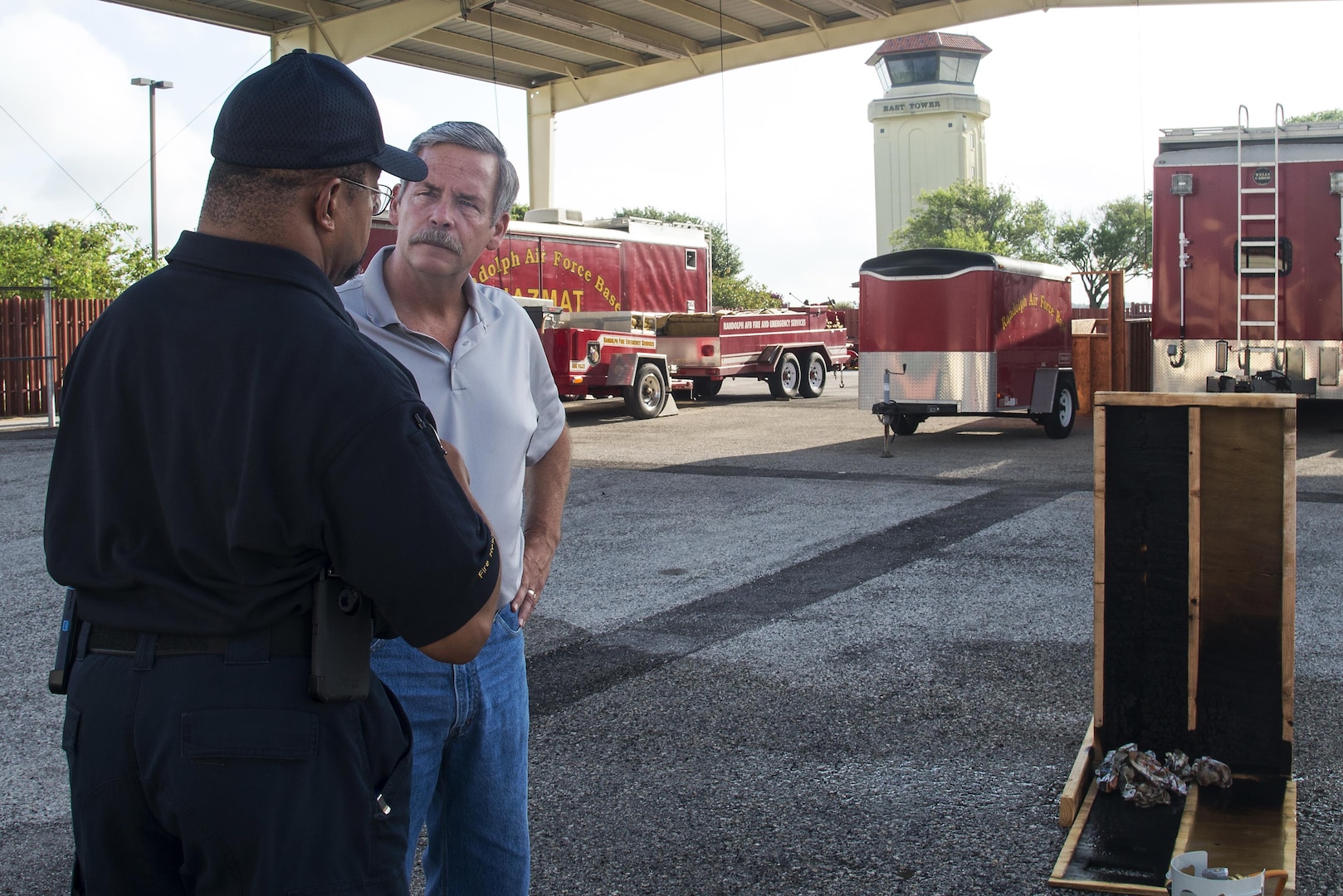 Bret Stohr, Insource fire service consultant and U.S. Air Force retired operations assistant chief, speaks with Patrick Lewis, Universal City Fire Department lieutenant, following a ventilation demonstration at Joint Base San Antonio-Randolph June 23, 2016. The demonstration was a part of a week-long Strategies and Tactics course presented by Insource, a Fire Service Training and Consulting company. 