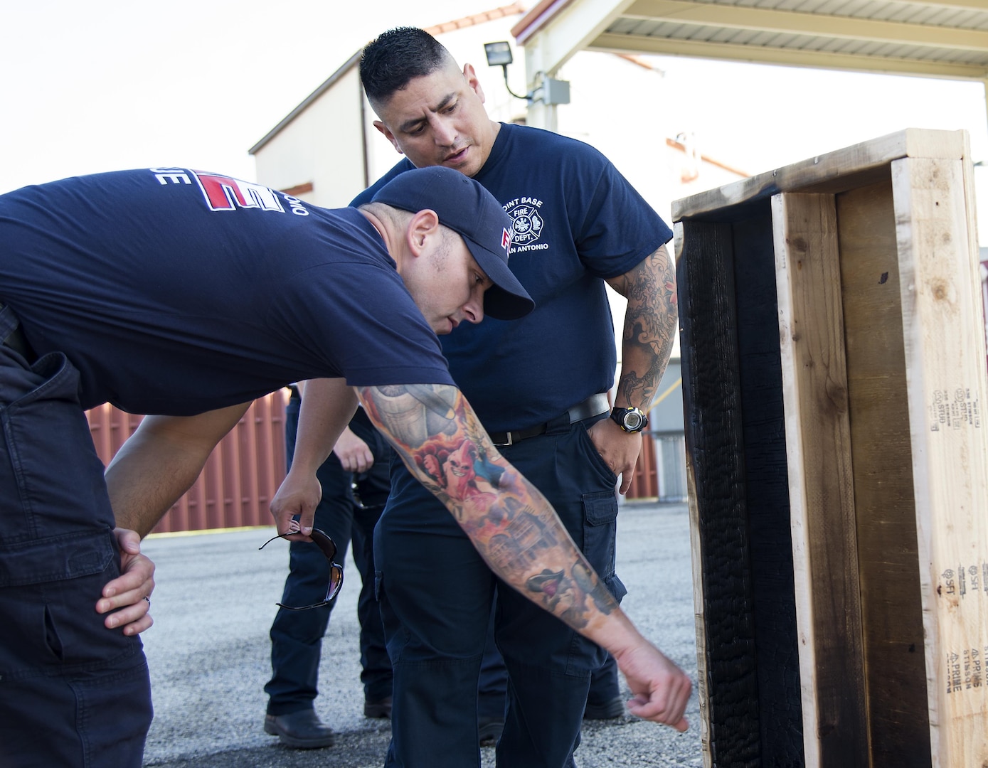 Members from the Joint Base San Antonio Fire Department examine a wood burn prop after a ventilation demonstration June 22 at Joint Base San Antonio-Randolph. The demonstration was part of a week-long Strategies and Tactics course that included instruction on fire growth, ventilation, rescue practices, types of construction for fire resistance and scene management, among other topics. 
