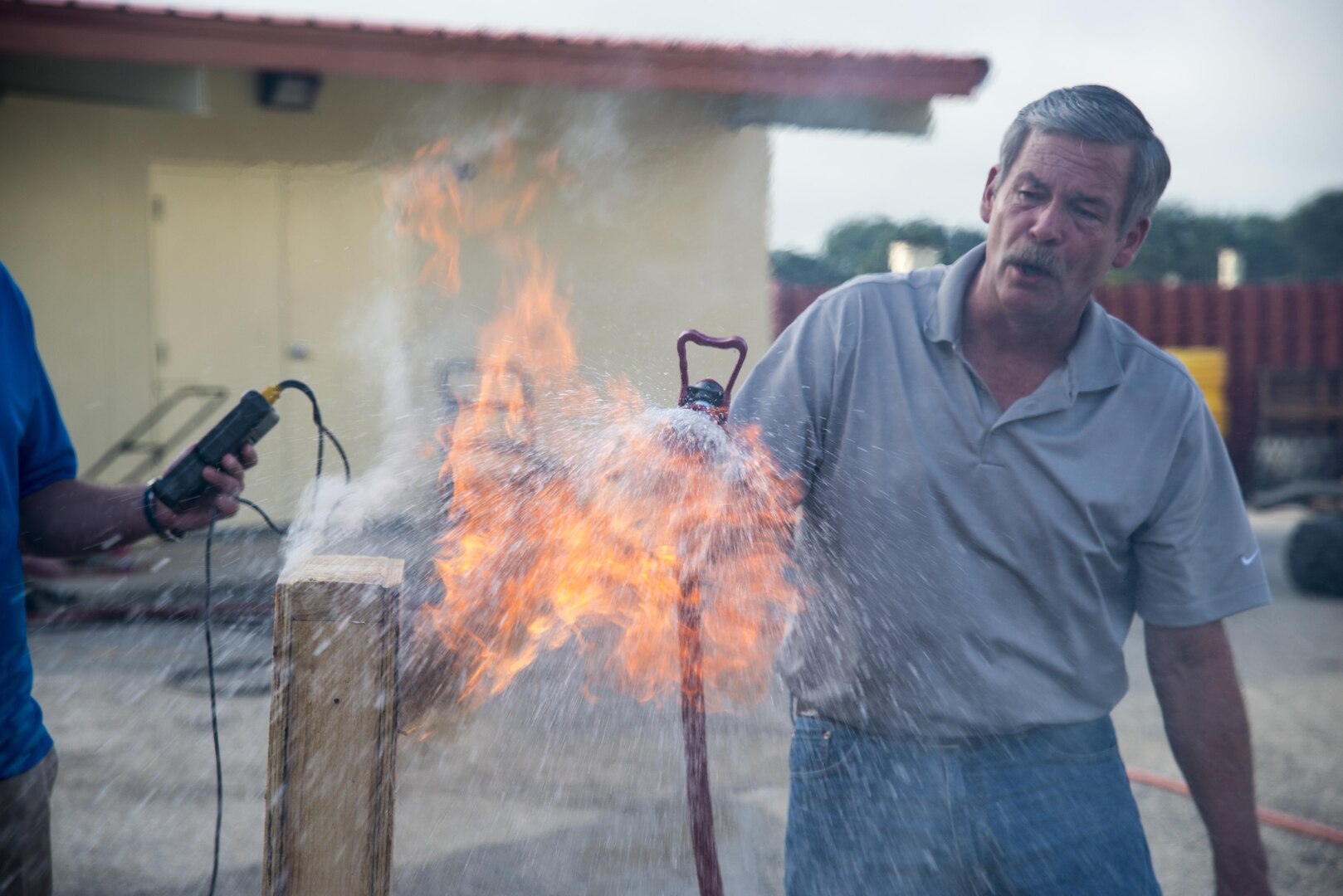 Bret Stohr, Insource fire service consultant and Department of Defense retired operations assistant chief, puts out a fire after a ventilation demonstration at Joint Base San Antonio-Randolph June 22, 2016. The demonstration was a part of a week-long Strategies and Tactics course presented by Insource, a fire service training and consulting company. 