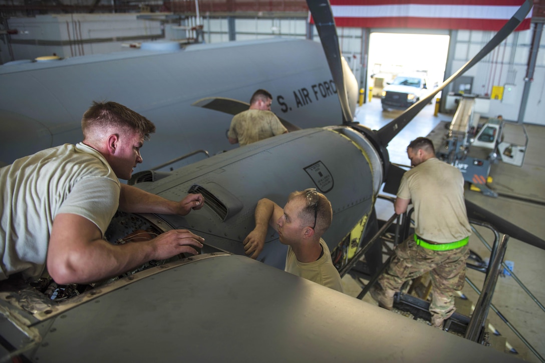 Left to right: Air Force Senior Airman Brady Thompson, Staff Sgt. Case Gadd, Senior Airman William Willmann and Senior Airman Charles Pearce replace an engine on a C-130J Super Hercules aircraft at Bagram Airfield, Afghanistan, June 27, 2016. Thompson, Gadd, Willmann and Pearce are maintainers assigned to the 455th Expeditionary Aircraft Maintenance Squadron. Air Force photo by Senior Airman Justyn M. Freeman