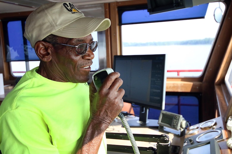 Captian Kelly Youngblood, speaks to a lock & dam operator as the Tulsa District U.S. Army Corps of Engineers navigation maintenance vessel, Mr. Pat, travels across Robert S. Kerr Lake on the McClellan-Kerr Arkansas River Navigation System to perform maintenance at Lock and Dam 15, near Sallisaw, Oklahoma, June 15, 2016. Mr. Pat was christened and put into service at the District on June 28, 1996, and for more than 20 years has been instrumental in the facilitation of maintenance along the Tulsa District's portion of the MKARNS. (U.S. Army Corps of Engineers photo by Preston Chasteen/Released)