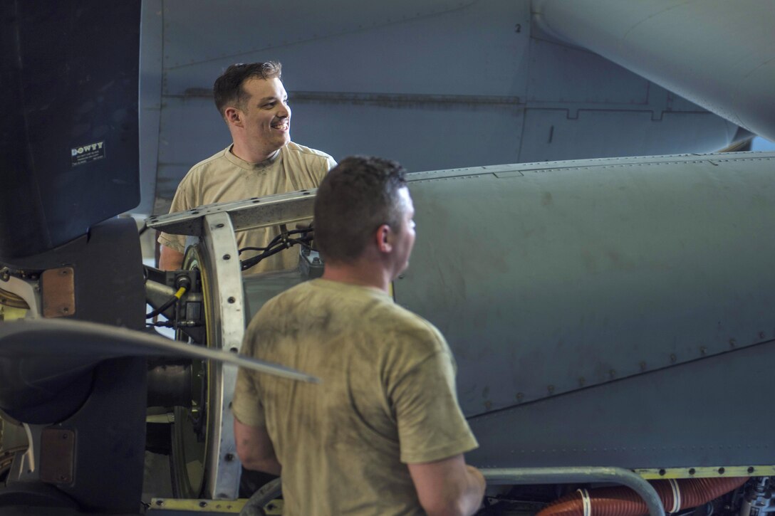 Air Force Senior Airman Charles Pearce, back, and Air Force Staff Sgt. Case Gadd replace an engine on a C-130J Super Hercules aircraft at Bagram Airfield, Afghanistan, June 27, 2016. Pearce and Gadd are engine maintainers assigned to the 455th Expeditionary Aircraft Maintenance Squadron. Air Force photo by Senior Airman Justyn M. Freeman     