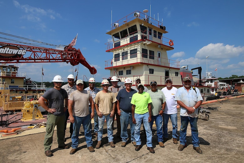 The Tulsa District U.S. Army Corps of Engineers navigation maintenance vessel Captain and crew stand in front of their boat, Mr. Pat, near Sallisaw, Oklahoma, June 15, 2016. Mr. Pat was christened and put into service at the District on June 28, 1996, and for the past 20 years has been instrumental in the facilitation of maintenance along the Tulsa District's portion of the McClellan-Kerr Arkansas River Navigation System. (U.S. Army Corps of Engineers photo by Preston Chasteen/Released)