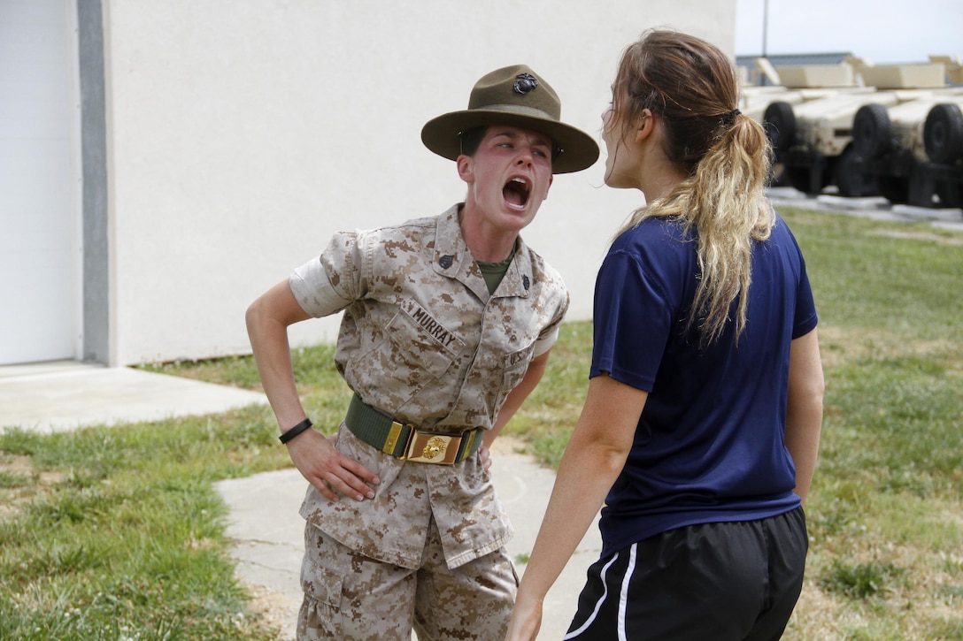 Staff Sgt. Jamie L. Murray, a Company P, 4th Battlation, Marine Corps Recruit Depot Parris Island chief drill instructor, instructs a poolee to give the proper greeting of the day during Marine Corps Recruiting Station Kansas City's all-hands pool function at Camp Clark in Nevada, Mo., June 24, 2016.