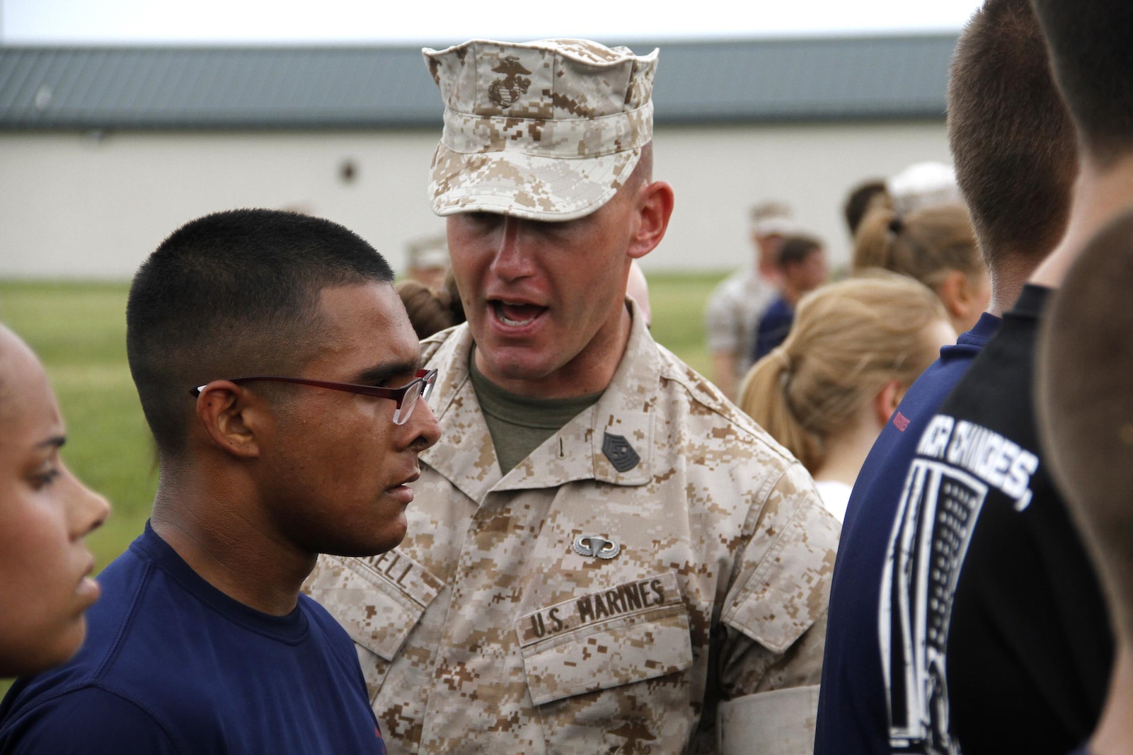 Sergeant Major Christopher A. Farrell, Marine Corps Recruiting Station Kansas City sergeant major, instructs a poolee on the dangers of not properly hydrating and displaying mental fortitude during strenuous exercise at RS Kansas City's all-hands pool function at Camp Clark in Nevada, Mo., June 24, 2016.