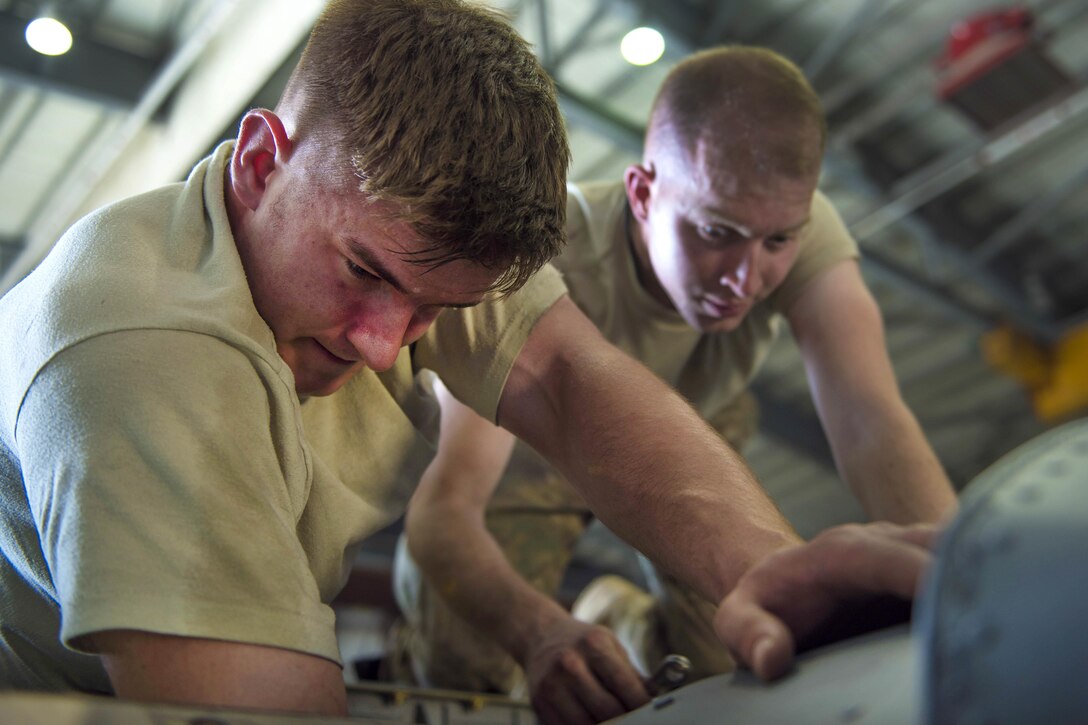 Air Force Senior Airmen Brady Thompson, left, and William Willmann replace a fire overheat protection system in a C-130J Super Hercules aircraft engine at Bagram Airfield, Afghanistan, June 27, 2016. Thompson and Willmann are environmental and electrical maintainers assigned to the 455th Expeditionary Aircraft Maintenance Squadron. Air Force photo by Senior Airman Justyn M. Freeman