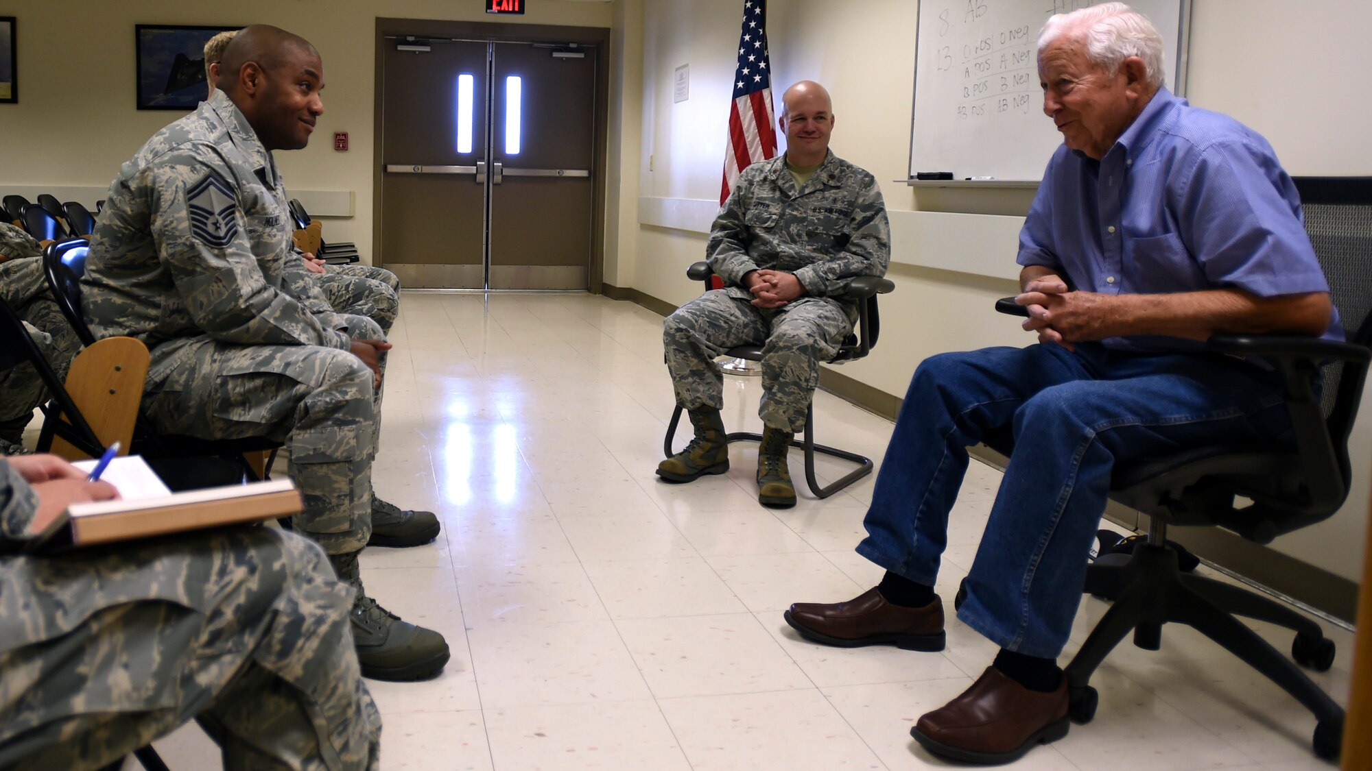 Retired Tech. Sgt. Arnold Parker (right), a Korean War veteran who worked in nutritional medicine on Lackland Air Force Base, Texas, in the early 1950s, speaks with members of the 59th Diagnostis and Therapeutics Squadron during a session of the deliberate development program June 20 at the Armed Services Blood Bank Center, Joint Base San Antonio-Lackland, Texas. The program develops Airmen of all ranks in areas, which include leadership, management and self-improvement. It encourages networking and access to other members of the medical team. (U.S. Air Force photo/Staff Sgt. Kevin Iinuma)