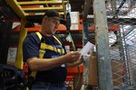 Defense Logistics Agency Aviation's, Rick Williamson, organic manufacturing product specialist with DLA Engineering Directorate, Richmond, Virginia, reviews warehouse items in a "not ready for issue" status at DLA Distribution San Joaquin in Tracy, California. Williamson was selected for the 2016 DLA Enterprise Rotation Program and during his three-month rotation, March - May, the value of the items he cleared and moved to distribution was $7.8 million. 