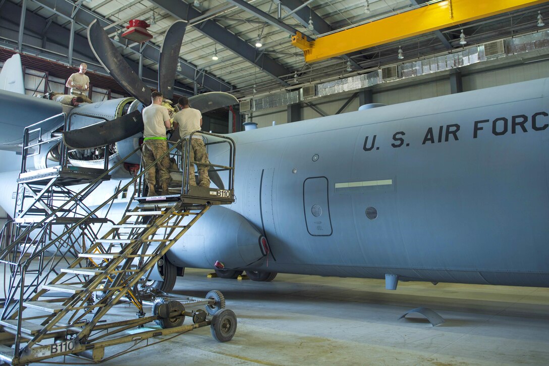 Airmen install a new engine on a C-130J Super Hercules aircraft engine at Bagram Airfield, Afghanistan, June 27, 2016. Air Force photo by Senior Airman Justyn M. Freeman