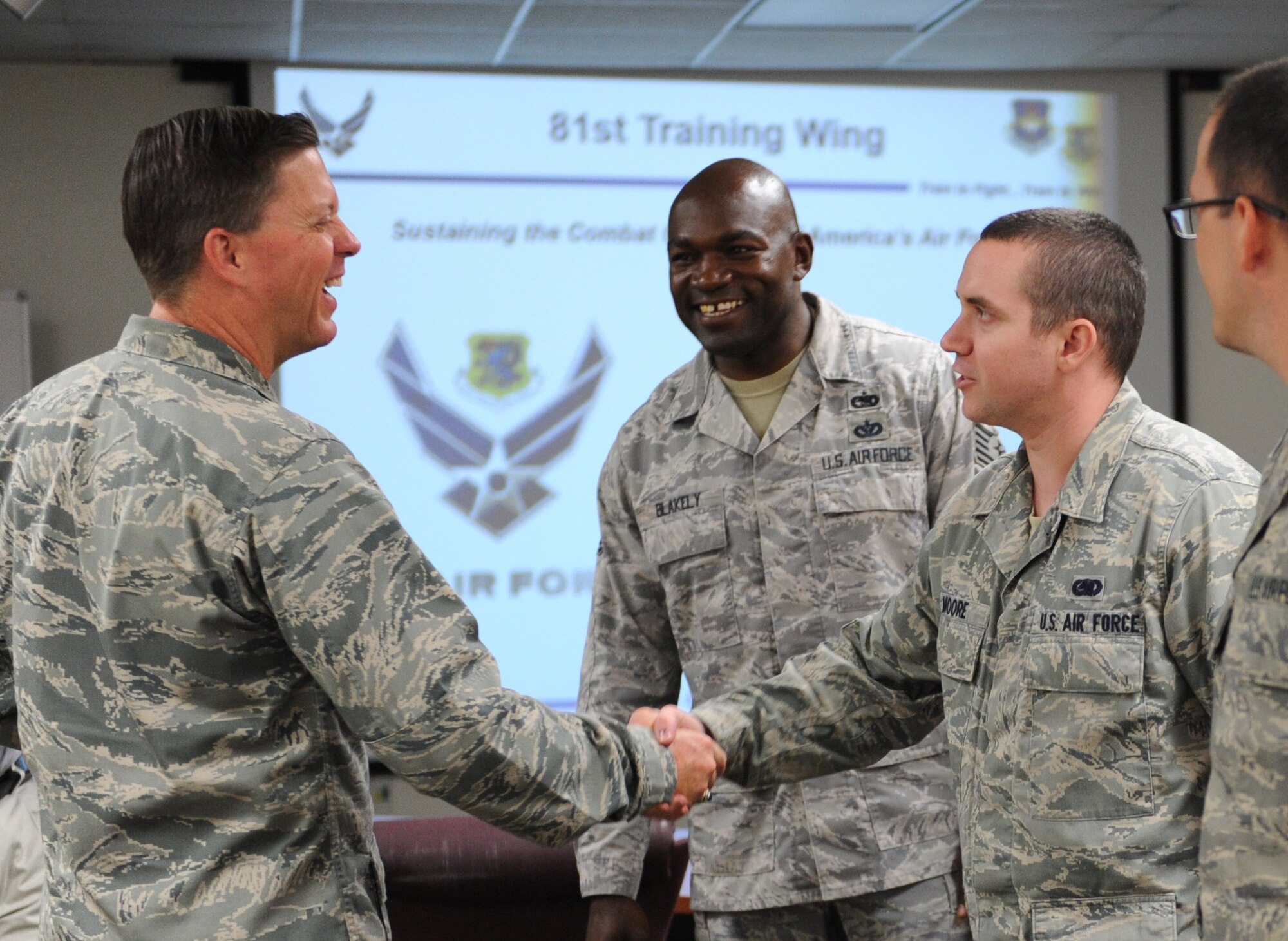 Col. C. Mike Smith, 81st Training Wing vice commander, is introduced to Tech. Sgt. Johnny Blakely, 81st Logistics Readiness Squadron deployment plans and integration NCO in charge, and Senior Airman Willie Moore II, 81st LRS deployment planning and execution supervisor, at the Taylor Logistics Center during an 81st Mission Support Group immersion tour June 23, 2016 on Keesler Air Force Base, Miss. The purpose of the tour was to become familiar with the group’s mission, operations and personnel. (U.S. Air Force photo by Kemberly Groue/Released)