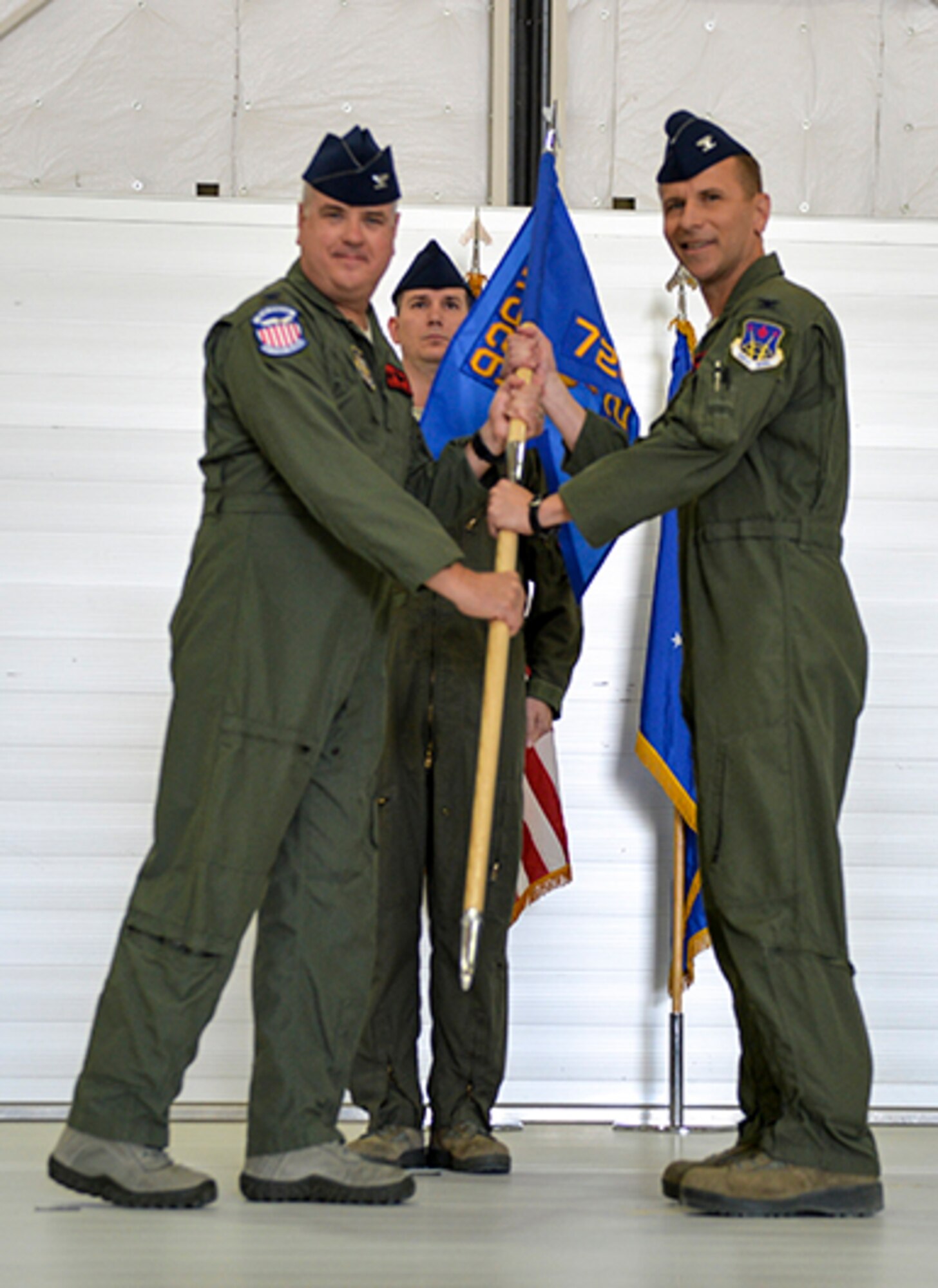 (Right) Col. David receives the 726th Operations Group guidon from Col. Ross Anderson, 926th Wing commander, upon becoming the squadron's new commander during a change of command ceremony at Creech Air Force Base, Nevada, on June 15. (U.S. Air Force photo/Airman First Class Kristan Campbell)