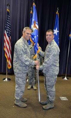U.S. Air Force Lt. Gen. Mark C. Nowland, 12th Air Force (Air Forces Southern) commander, hands the 557th Weather Wing guidon to U.S. Air Force Col. Steven Dickerson, during a change of command ceremony at the 557th WW Auditorium June 24 on Offutt Air Force Base, Nebraska. Dickerson took command from U.S. Air Force Col. William Carle. (U.S. Air Force photo by Zachary Hada)