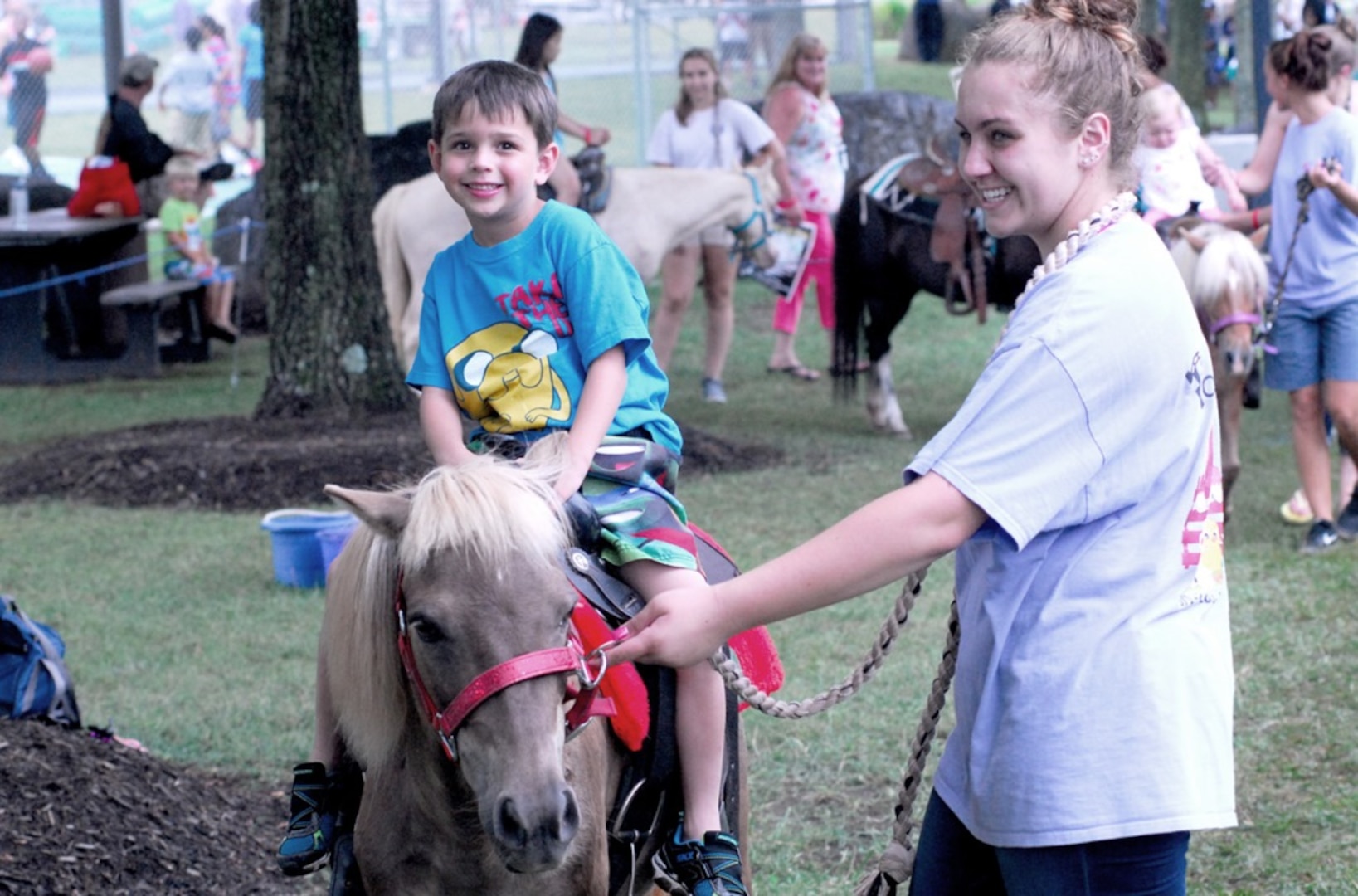 Caleb Hasley, 6, is all smiles on the pony ride during one of the many events at the McNamara Headquarters Complex Family Day June 28.