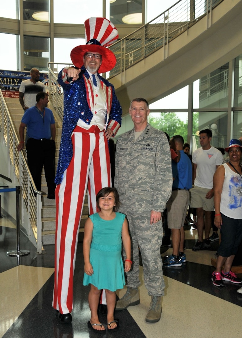 Defense Logistics Agency Director Air Force Lt. Gen. Andy Busch kicked off the 2016 HQC Family Day at the McNamara Headquarters Complex at Fort Belvoir, Virginia, June 28.  Here he is joined by Uncle Sam and 7-year-old Kailyn Stack.