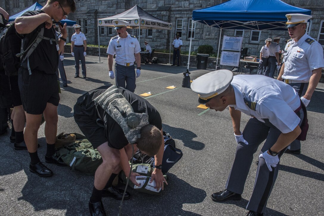 A future Cadet at the U.S. Military Academy at West Point, N.Y., struggles to find his Cadet Basic Training Smart Book during R-day, June 27. (U.S. Army photo by Sgt. 1st Class Brian Hamilton/ released)