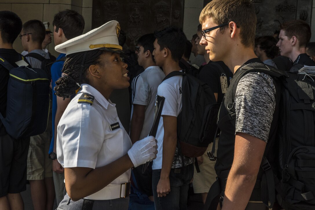 Cadet Ariana McConneauchey lectures a future Cadet on the importance of not leaving his personal items lying around in front of Thayer Hall at the U.S. Military Academy at West Point, N.Y., June 27. (U.S. Army photo by Sgt. 1st Class Brian Hamilton/ released)