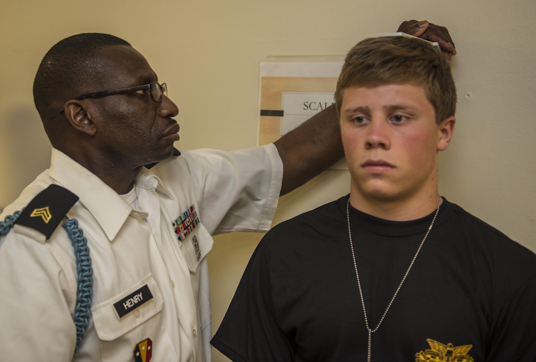Army Reserve Sgt. Clifford Henry, 2nd Battalion, 113th Infantry Regiment (USMA), 104th Training Division (LT), measures the height and weight of  a future Cadet during R-day at the U.S. Military Academy at West Point, N.Y., June 27. (U.S. Army photo by Sgt. 1st Class Brian Hamilton/ released)