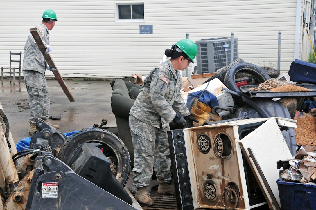 Soldiers help clean up debris from flooding in Rainelle, W.Va., June 27, 2016. The soldiers, assigned to the Rhode Island Army National Guard’s 861st Engineer Company, stayed in West Virginia to assist after completing their annual training. Army National Guard photo by Staff Sgt. Justin Hough