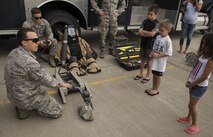 Airman 1st Class Connor Finch, 5th Civil Engineer Squadron explosive ordinance disposal apprentice, demonstrates his job to Minot youth during Heroes in Training at Minot Air Force Base, N.D., June 24, 2016. Heroes in Training showcased displays from the fire department, security forces, medical group and other first responding base agencies. (U.S. Air Force photo/Airman 1st Class Christian Sullivan)