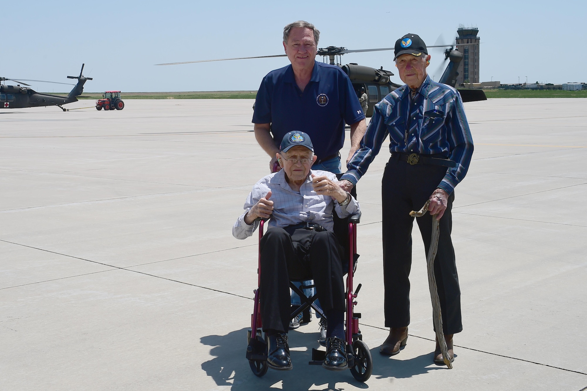 Ret. U.S. Air Force Lt. Col. Morris L. Quick Jr., his son Edward Quick and Ret. U.S. Air Force Col. Bill Myers, pose for a photo in front of a Sikorsky UH-60 Black Hawk helicopter June 17, 2016, at the Army Aviation Facility on Buckley Air Force Base, Colo. Quick and Myers are both part of the Order of Daedalians, which honors WWI aviators as the first to fly United States aircraft in a time of war. The two men, now in their late 90’s, both served in WWII, Korea and Vietnam. Both men have a connection with Colorado. Quick flew out of Buckley Field during WWII and Myers was a part of the Colorado Air National Guard. (U.S. Air Force photo by Airman 1st Class Luke W. Nowakowski/Released)