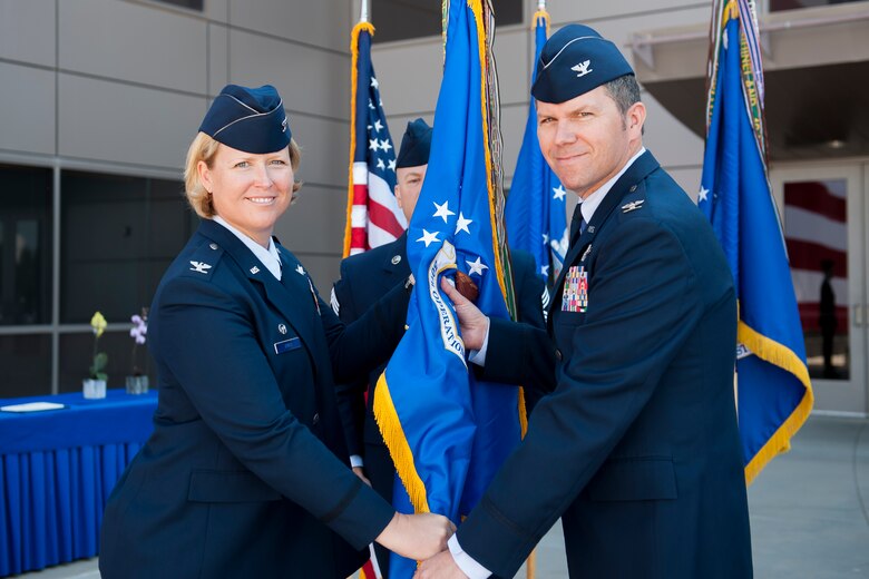 Col. DeAnna Burt, 50th Space Wing commander, presents the guidon to Col. Toby Doran during the 50th Operations Group change of command ceremony at Schriever Air Force Base, Colorado, Monday, June 27, 2016. Doran assumed group command from Col. Dennis Bythewood. (U.S. Air Force photo/Dennis Rogers)
