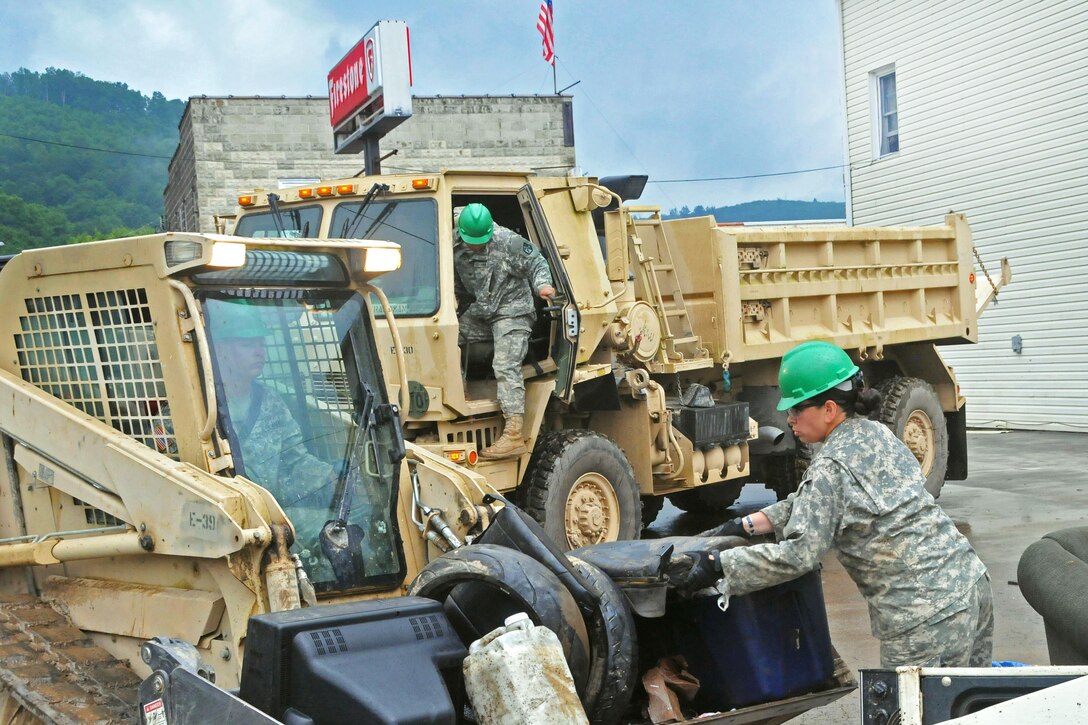 Soldiers help remove debris after flooding in Rainelle, W.Va., June 27, 2016. Army National Guard photo by Staff Sgt. Justin Hough